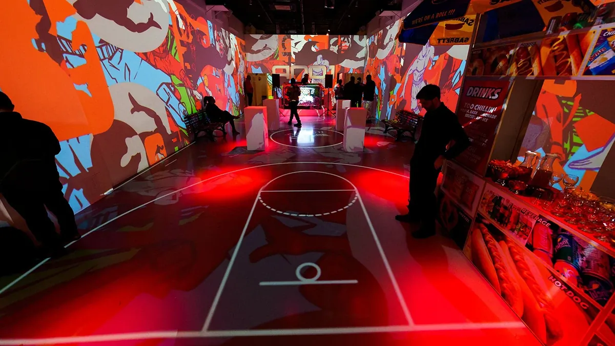 Immersive comic art projections across a basketball court floor at LUME
